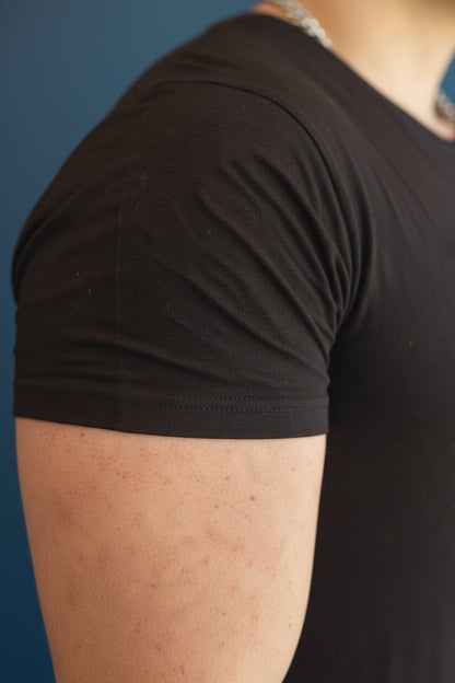 B.Balanced Co black bamboo blend Everyday Tee featuring a soft, breathable four-way stretch fabric on a male model.