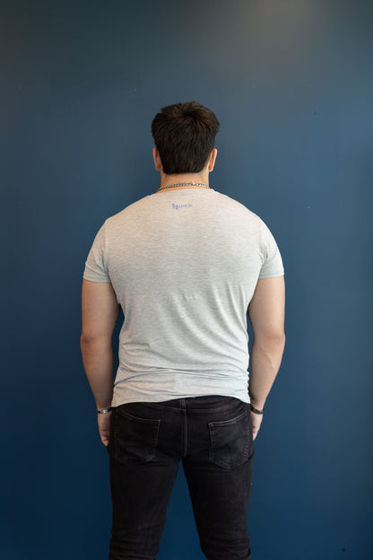Back view of a man wearing a B.Balanced Co heathered grey crew neck t-shirt with small branding on the upper back