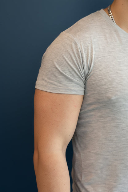 Close-up of a man wearing a B.Balanced Co heathered grey crew neck t-shirt with a soft-touch, tailored fit.